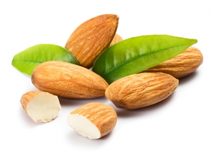 Almonds with leaves isolated on white background