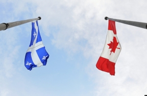 Quebec and Canada flying flags were photographed in Montreal on July 1, 2009. The Canadian Press Images/Denis Beaumont