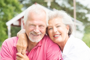 Happy and smiling senior couple at the beach